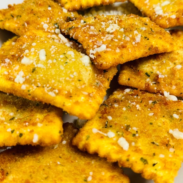 Close-up of golden-brown fried ravioli, sprinkled with parmesan cheese and herbs, from Casa D'angelo.